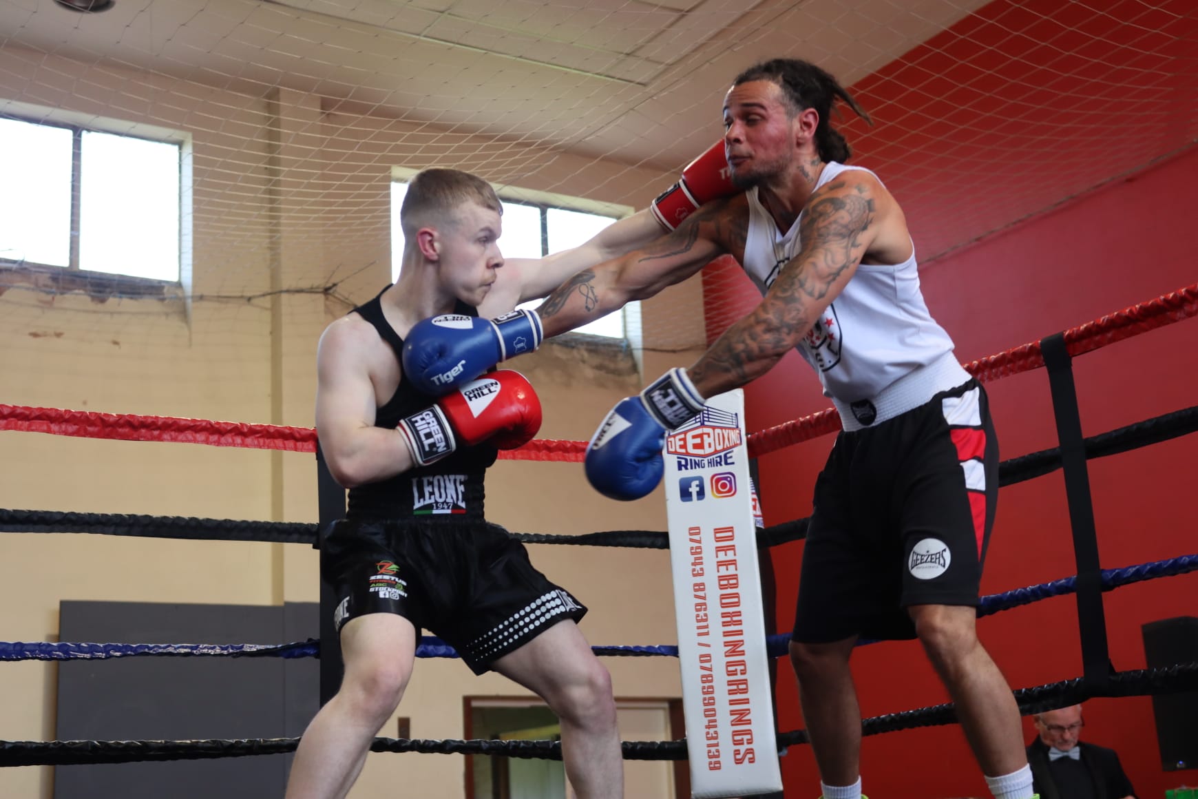 A Zestus boxer trading punches in the ring at an amateur show.