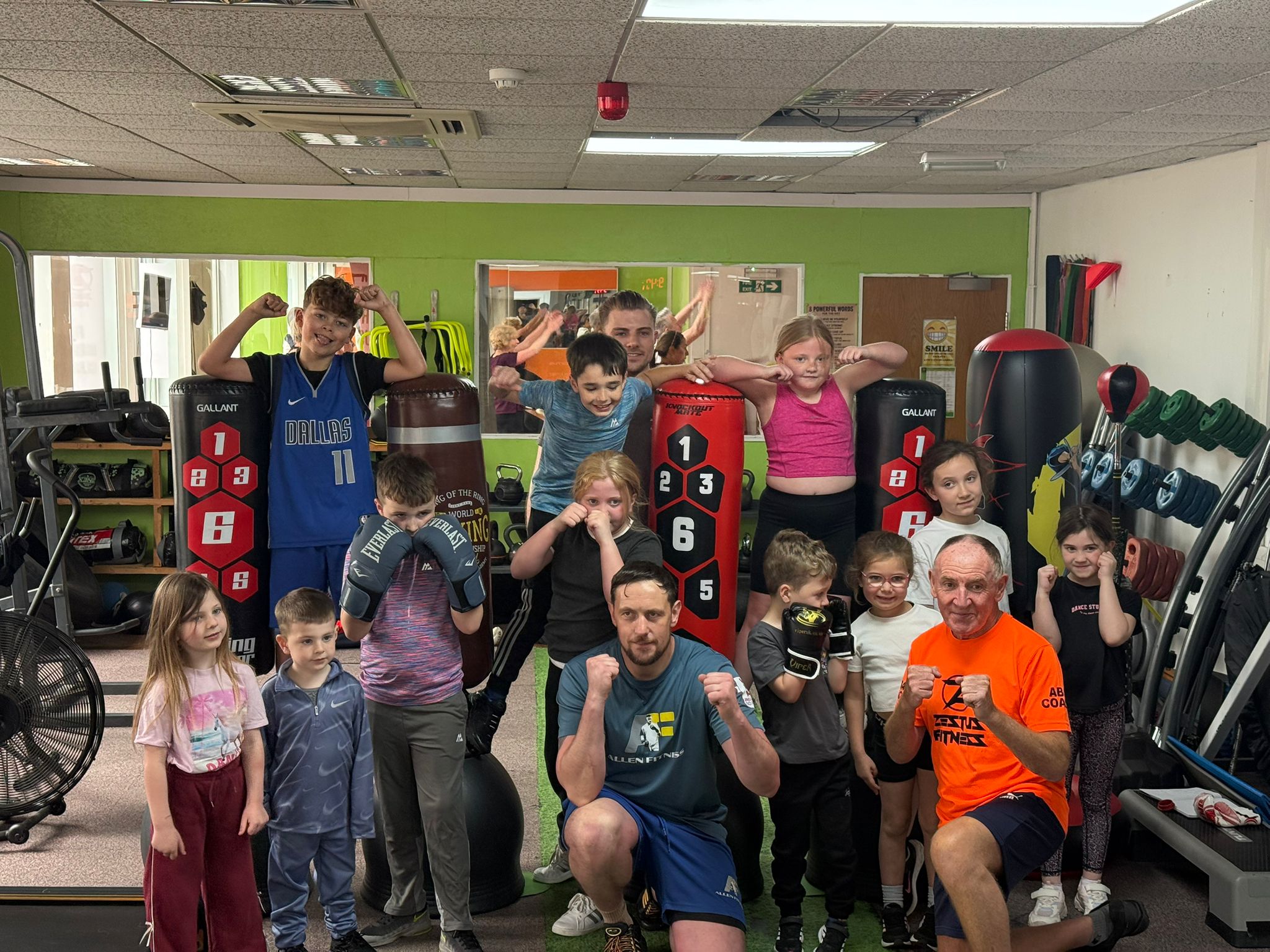 Coaches and young members of the boxing club gathered in the gym.
